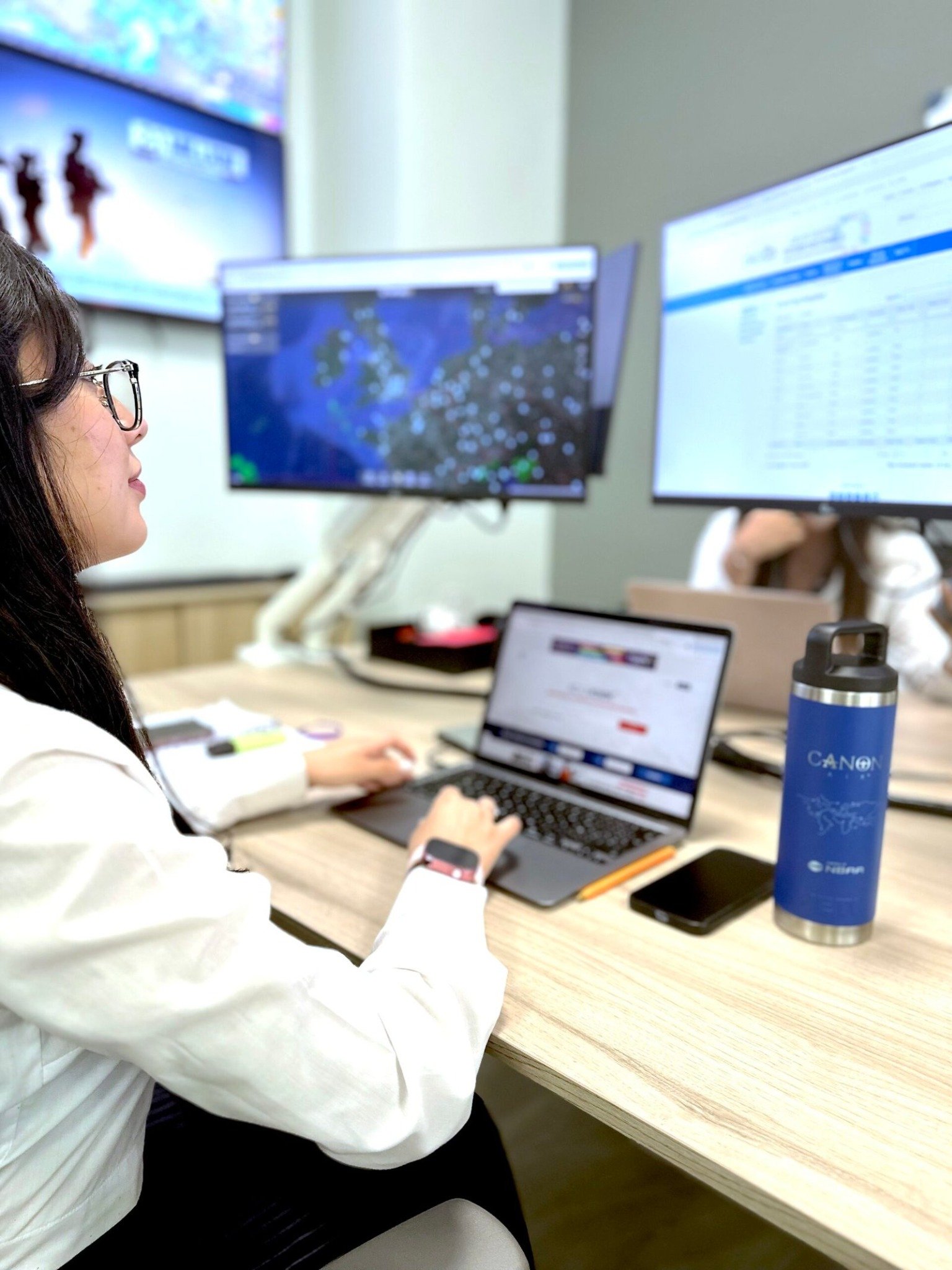 Canon Air team member working with flight information